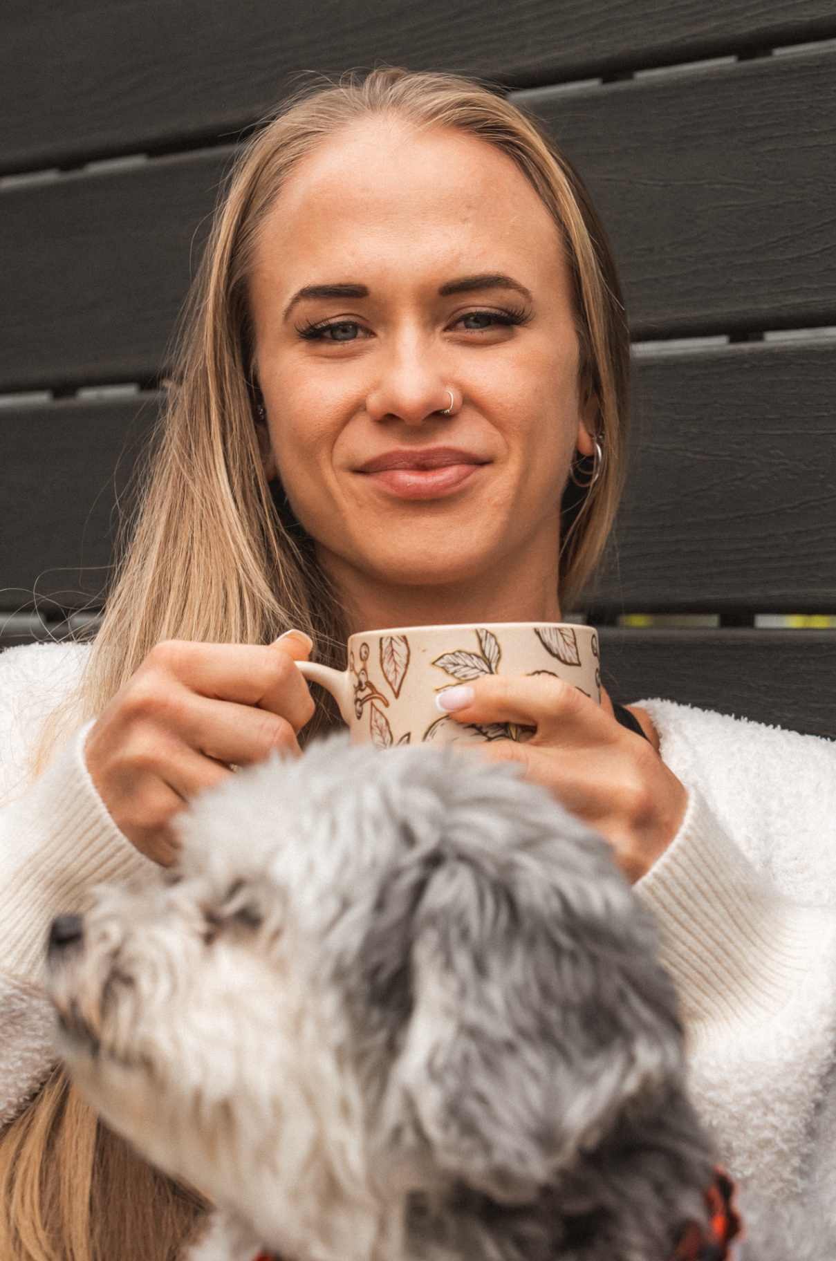 Sarah smiling with a mug, soft morning light